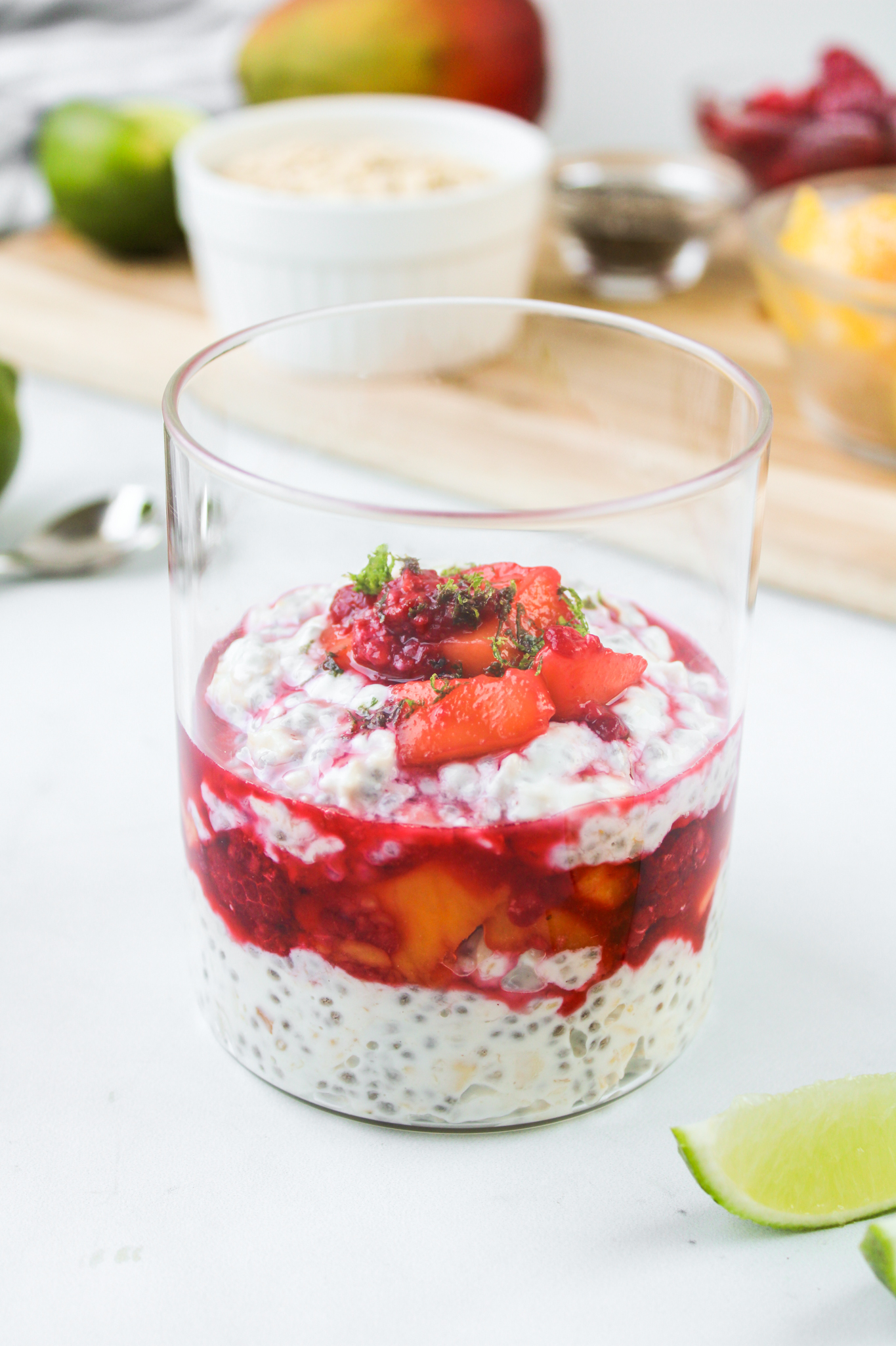 mango overnight oats in a glass jar with ingredients used in the background
