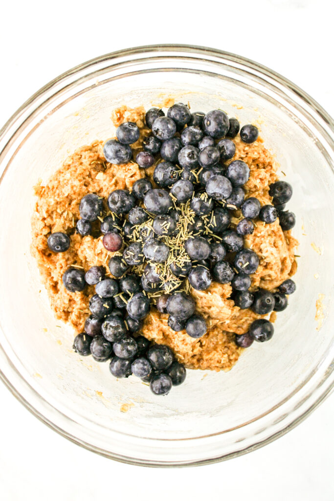 muffin batter with blueberries and rosemary