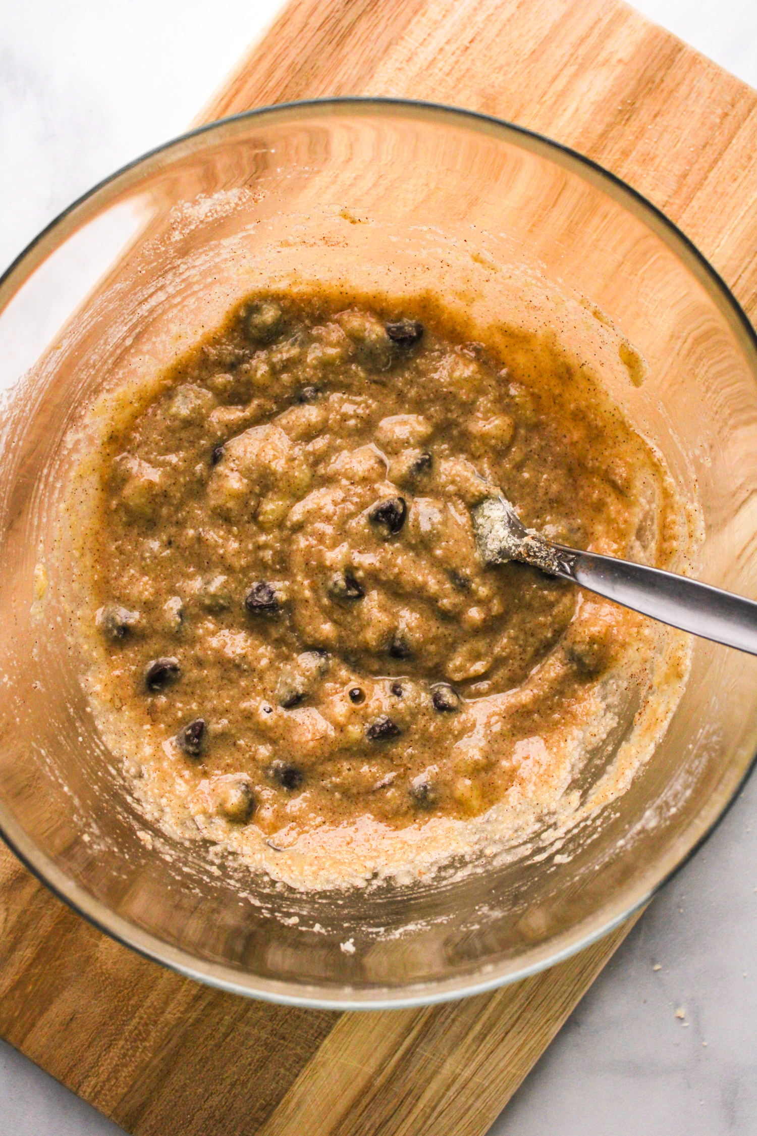almond flour pancake batter in a glass bowl on top of a wooden board