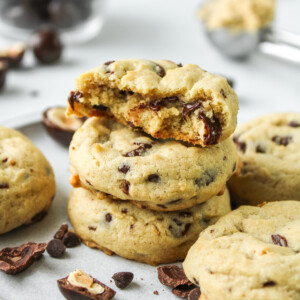 hazelnut chocolate chip cookies stacked on top of each other with cookies surrounding them