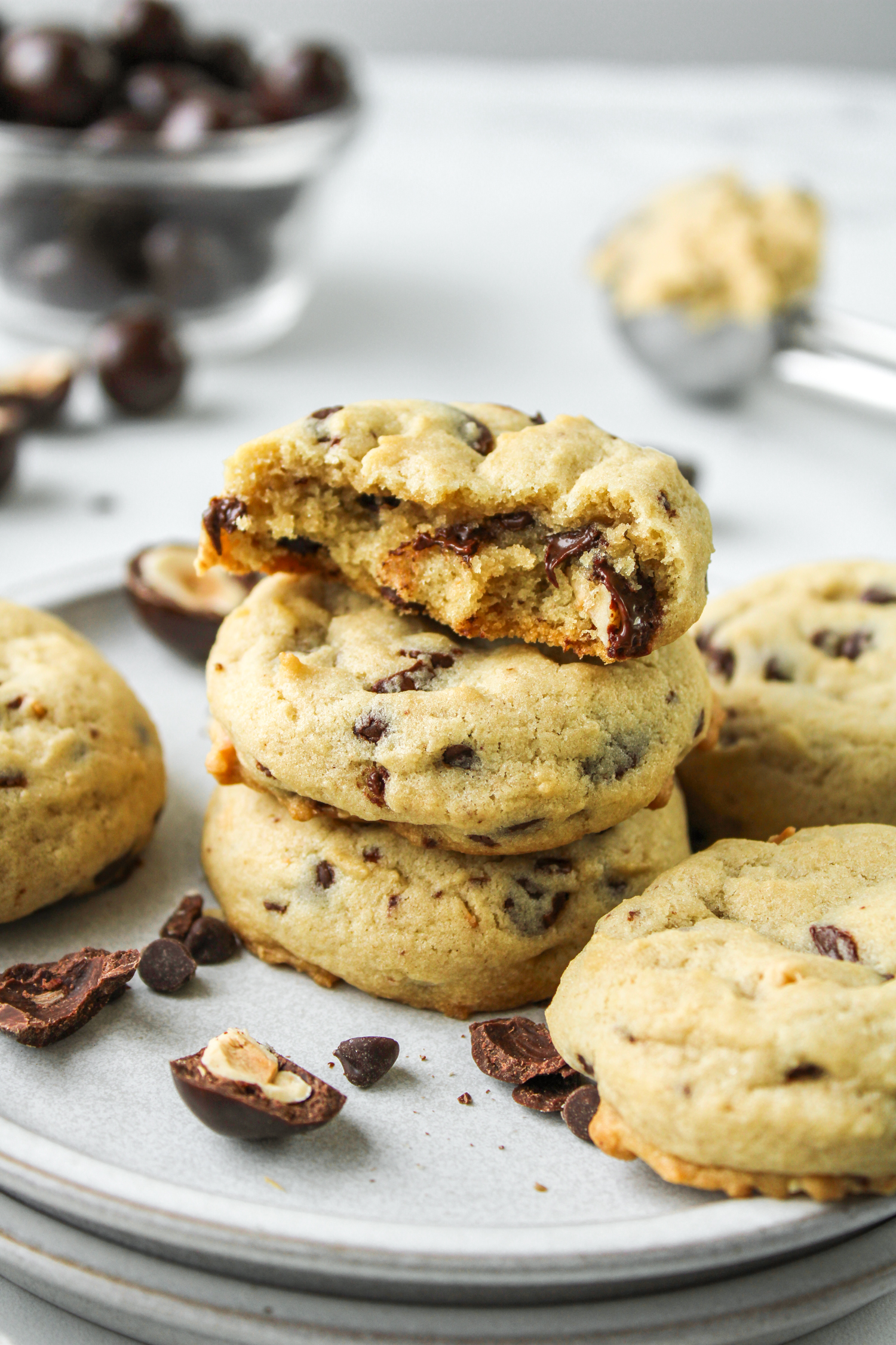 hazelnut chocolate chip cookies stacked on top of each other with cookies surrounding them
