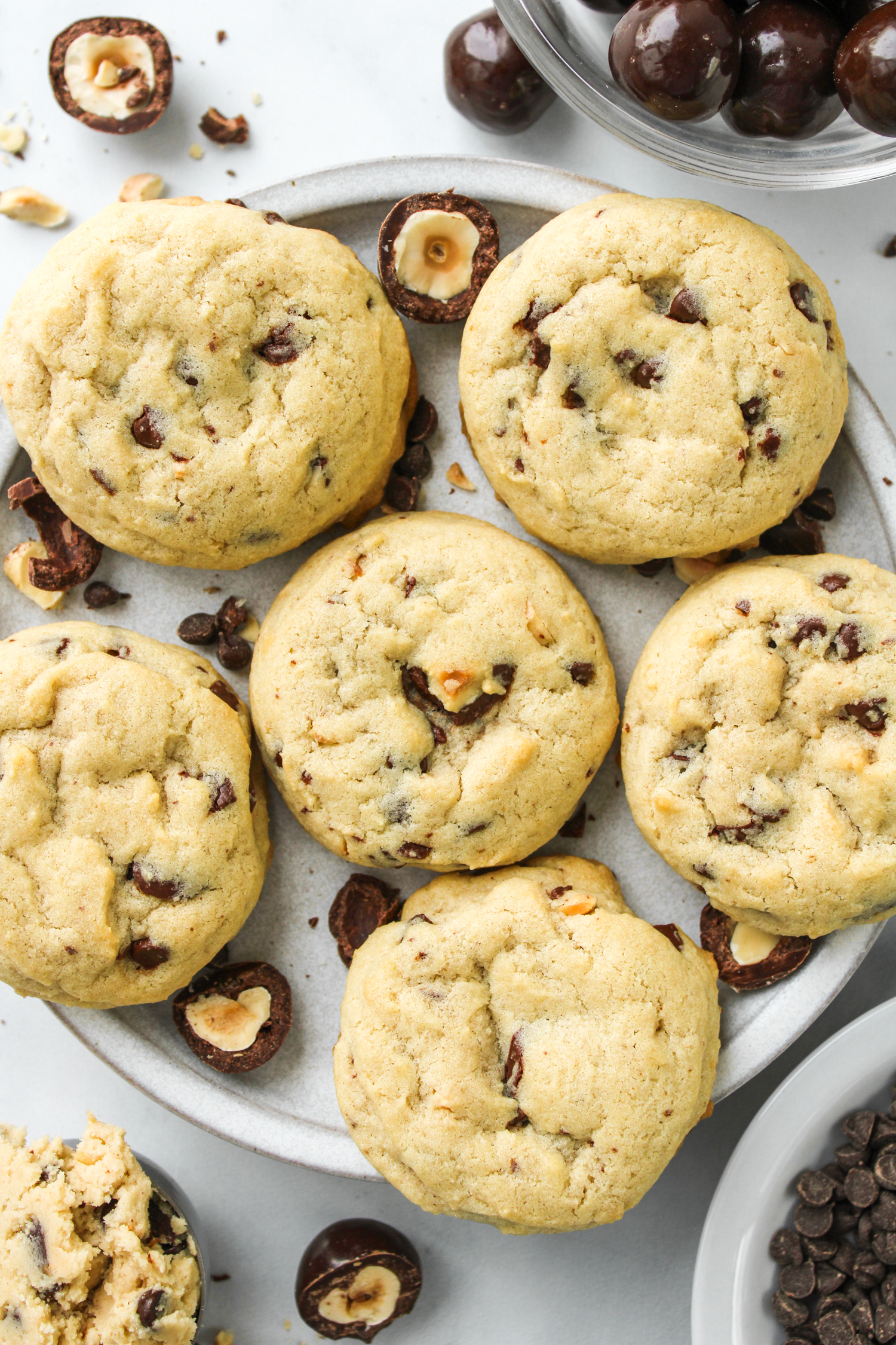 hazelnut chocolate chip cookies spread out on a grey ceramic plate