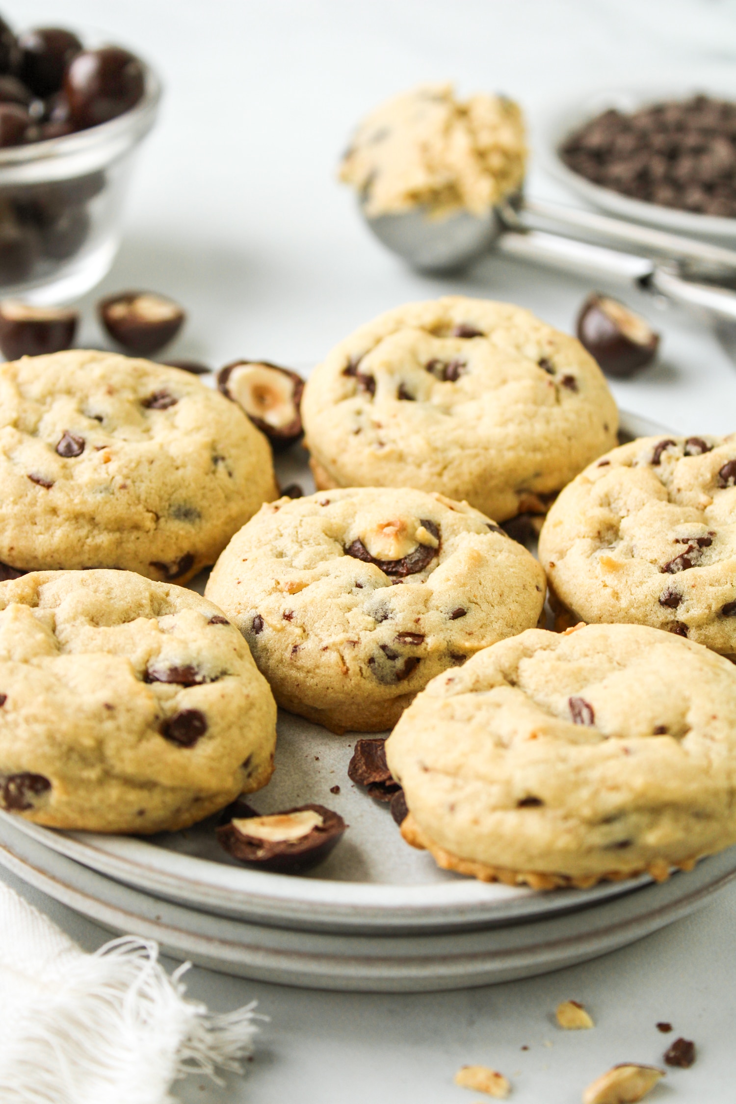 side profile of hazelnut chocolate chip cookies laid out on a grey ceramic plate
