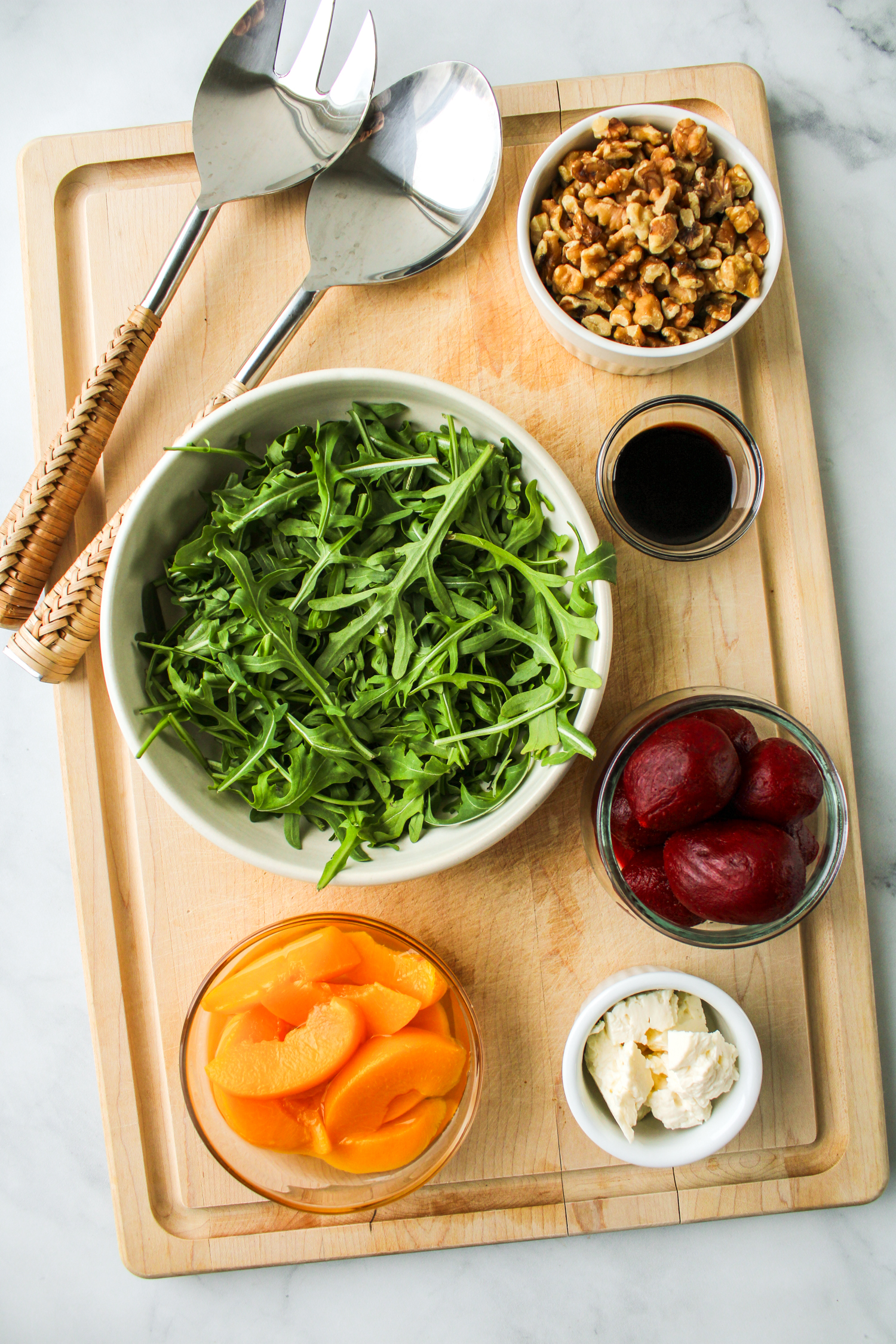 ingredients for beetroot salad laid out on a wooden board