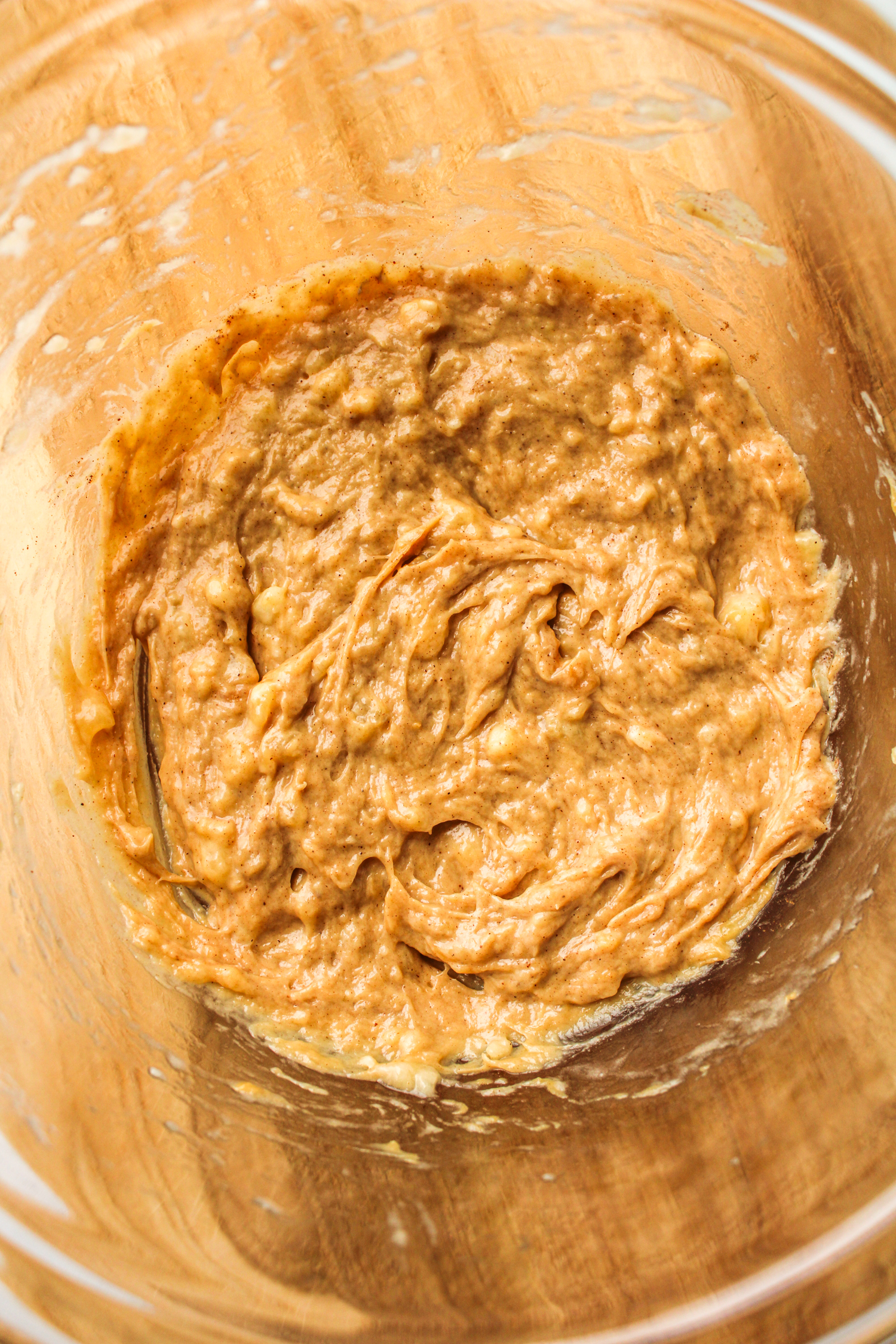 banana and peanut butter filling in a glass bowl on top of a wooden cutting board