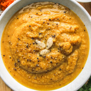 cauliflower pumpkin soup in white ceramic bowl topped with pumpkin seeds