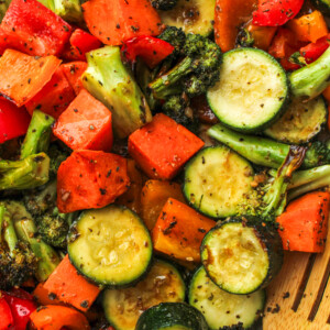 air fryer roasted vegetables with maple balsamic dressing and a wooden spoon to scoop them up