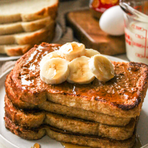biscoff sourdough french toast topped with biscoff spread, sliced bananas and maple syrup