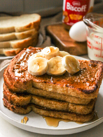 biscoff sourdough french toast topped with biscoff spread, sliced bananas and maple syrup