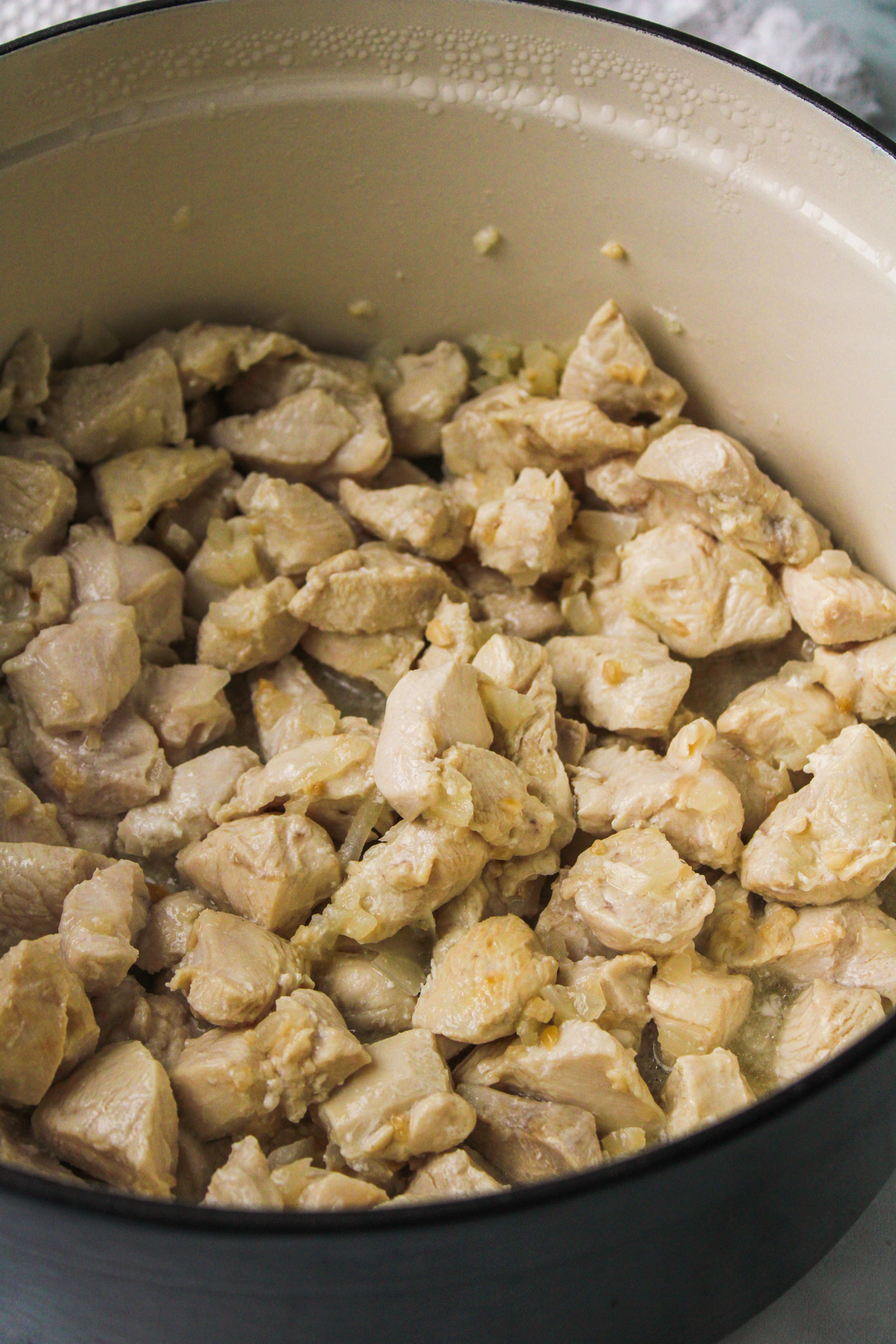 cooked chicken in a large ceramic cooking pot