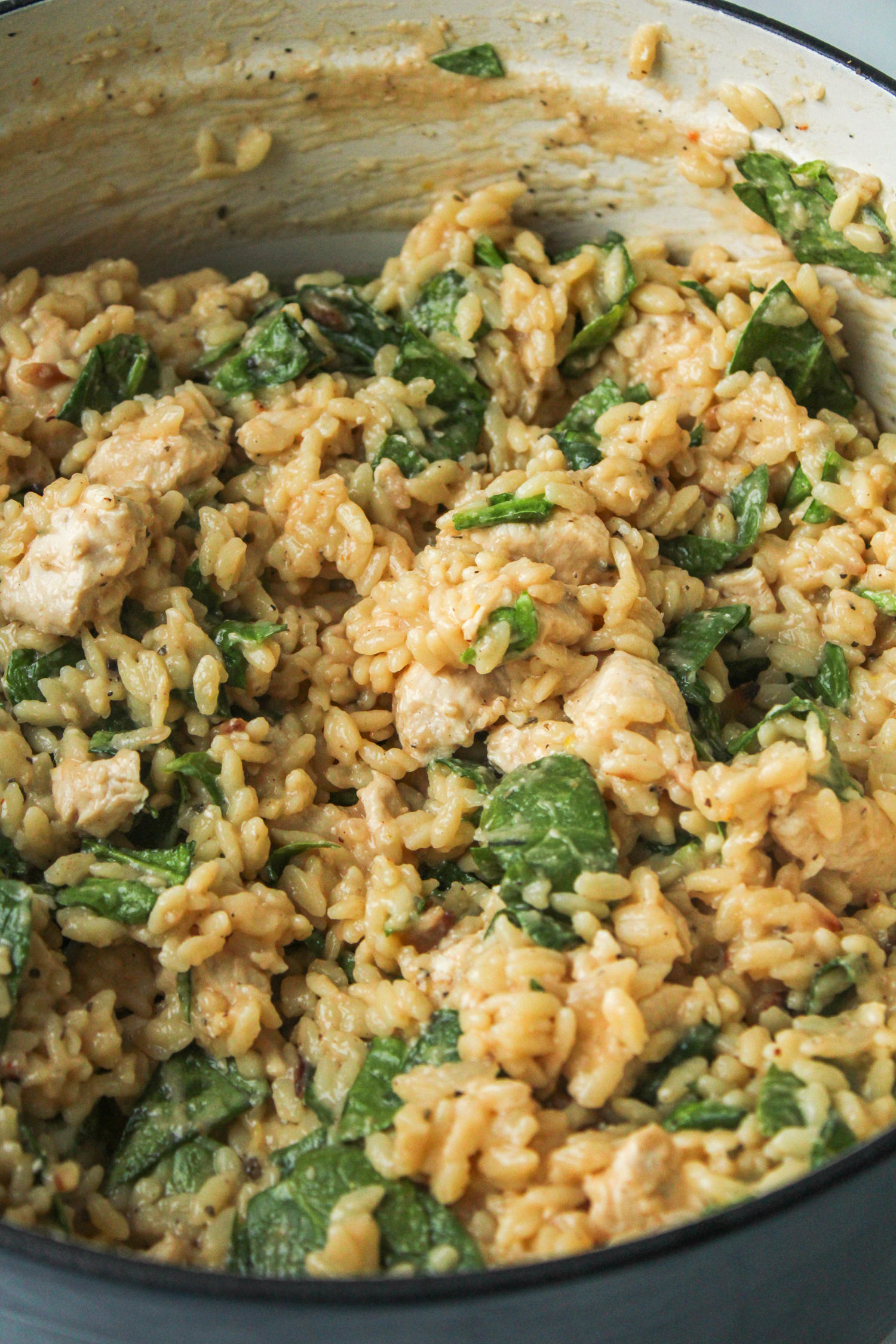 cooked orzo, chicken and spinach in a large pot