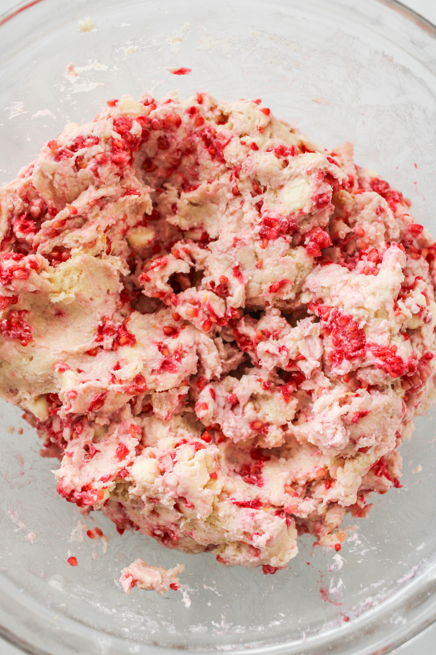 white chocolate raspberry scone batter in a large glass bowl