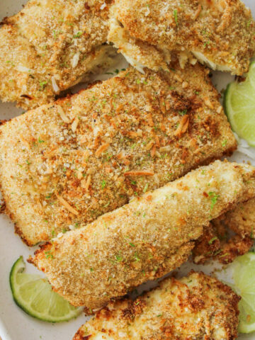 overhead shot of coconut lime air fryer halibut fillets on a large white ceramic plate
