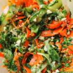 cucumber carrot salad in a large glass bowl
