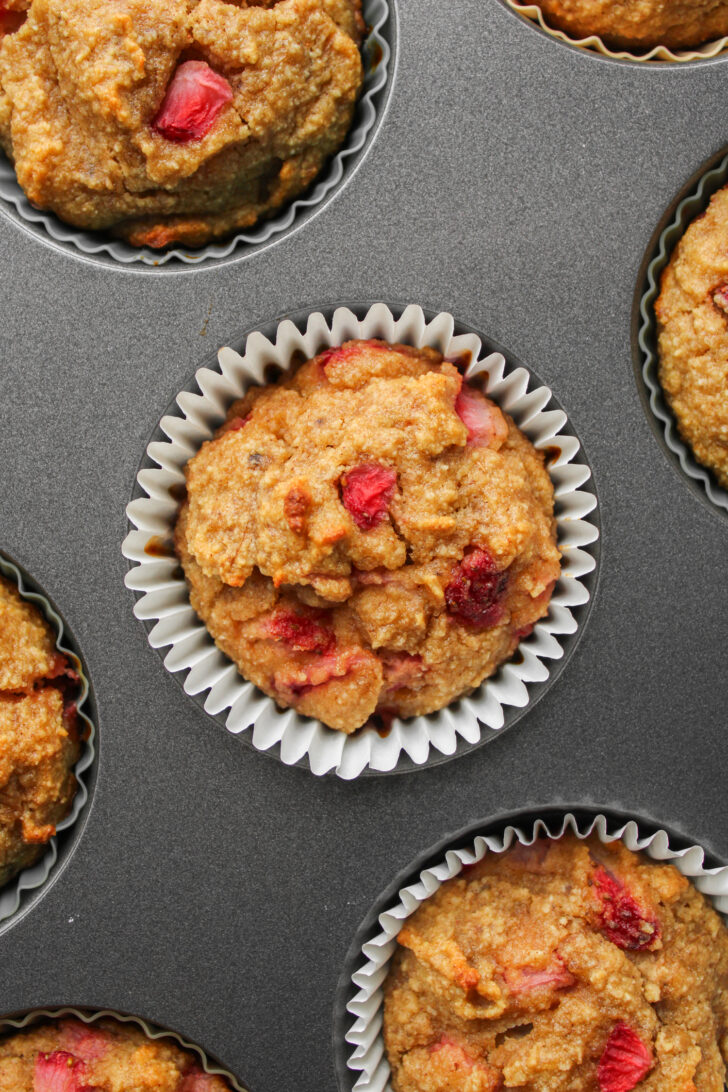 baked almond flour muffins with banana and strawberry in the muffin pan