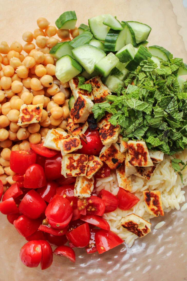 chickpea halloumi salad ingredients in a large bowl