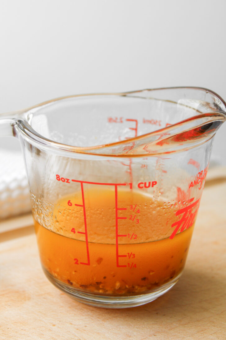 chili oil vinaigrette in a glass measuring cup