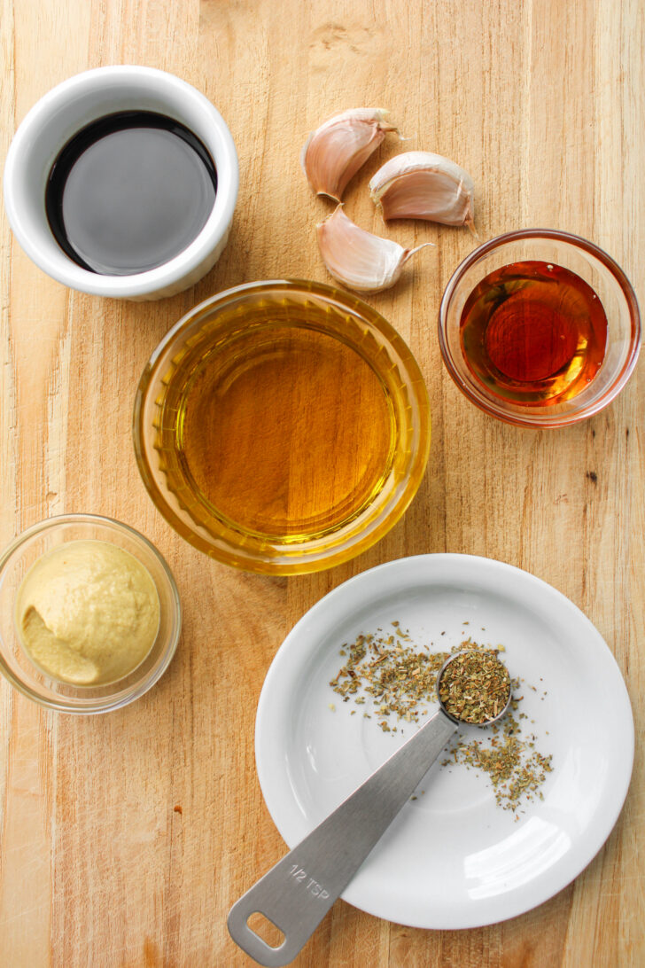 ingredients needed for maple balsamic dressing on a wooden board