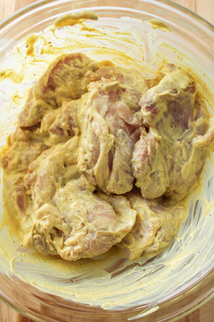 raw chicken thighs in greek yogurt curry marinade