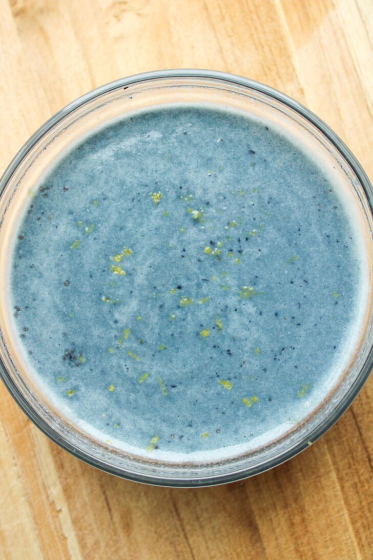 chia seeds and blueberry milk in a glass bowl