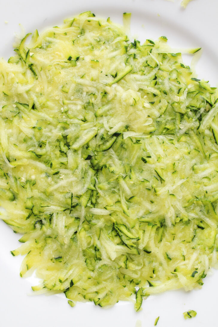 grated zucchini on a white plate