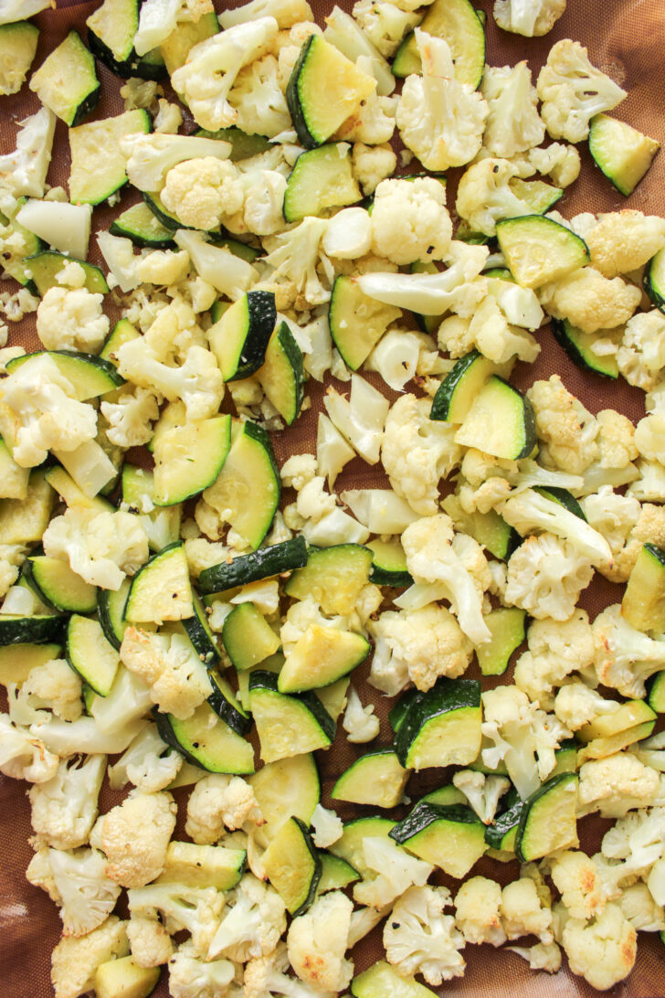 roasted cauliflower and zucchini on a baking sheet