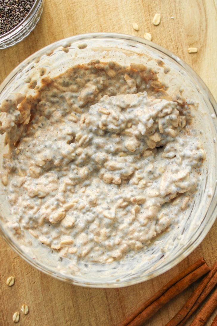 overnight oats mixed with the cinnamon sugar in a glass bowl