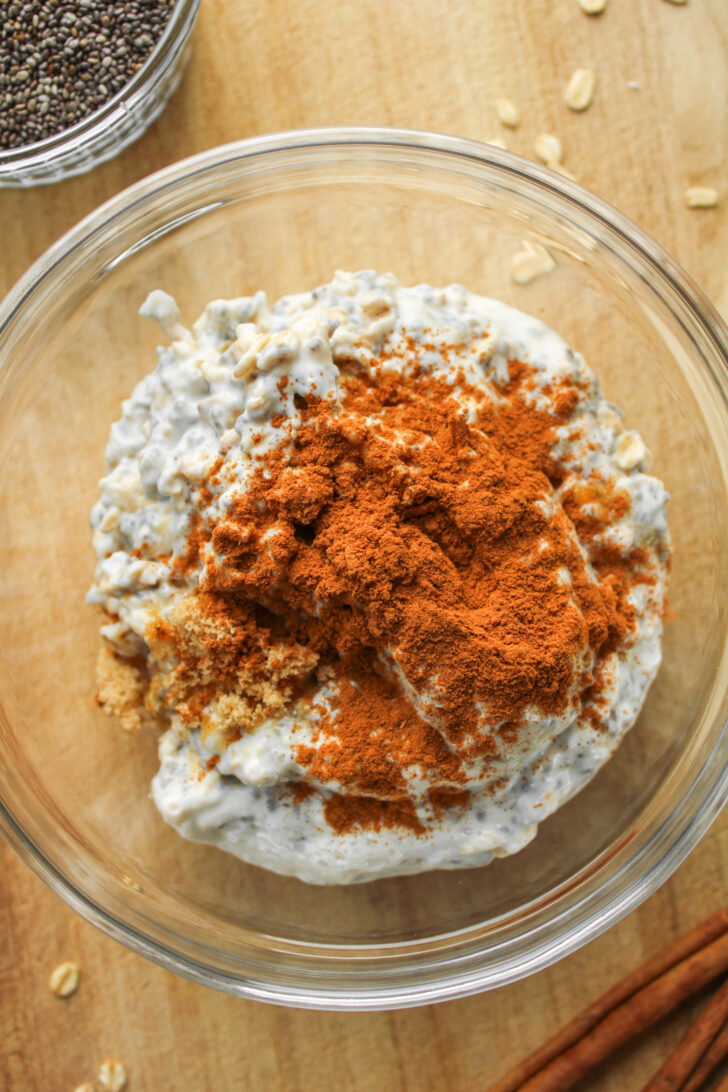 plain overnight oats with cinnamon sugar sprinkled on top in a glass bowl