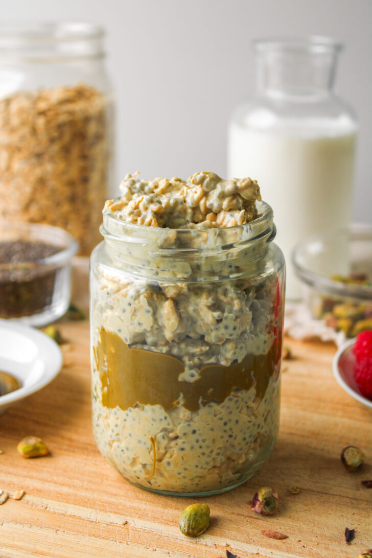 overnight oats with pistachio cream layered in the middle and mixed in