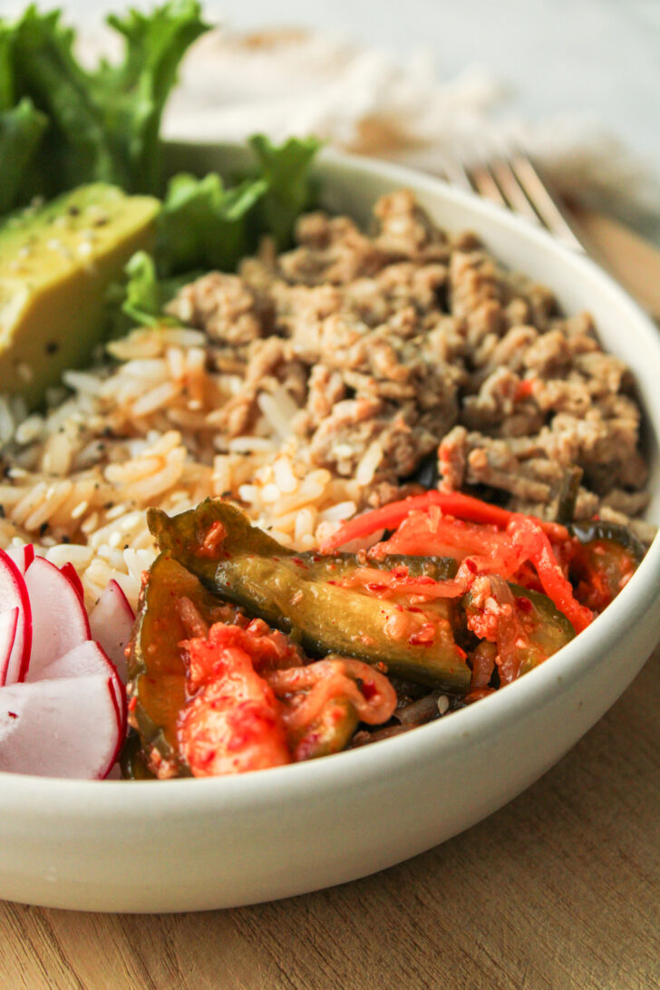 kimchi in a rice bowl in a white ceramic bowl